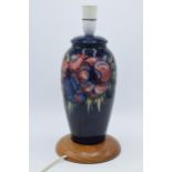 Moorcroft pottery lampbase in the Clematis (or similar) floral pattern on turned wooden base, 28cm