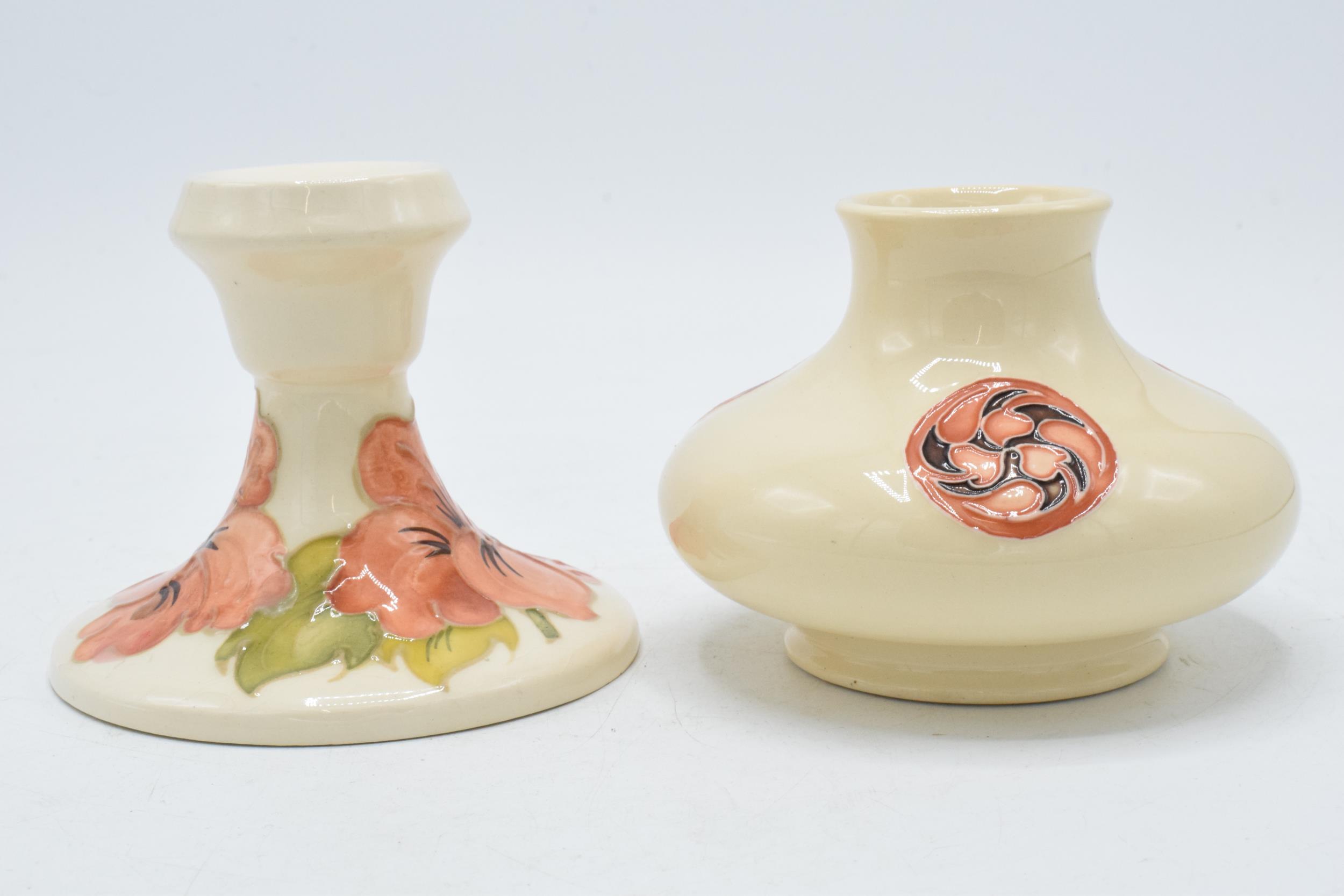 Moorcroft squat vase decorated with a Florian vase (red dot) together with Hibiscus candlestick (2).