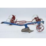 A trio of vintage 20th century metal farm machines to include a plough and 2 others, longest 38cm (