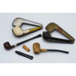 A collection of pipes to include a Toasted and Broken example, a briar pipe, and others with 2 cases