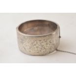 Silver wide engraved bangle with floral decoration, Chester 1957, 52.2 grams. Dent to rear.