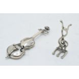 A pair of silver miniature figures of a double bass and treble clef (or similar), combined weight 15