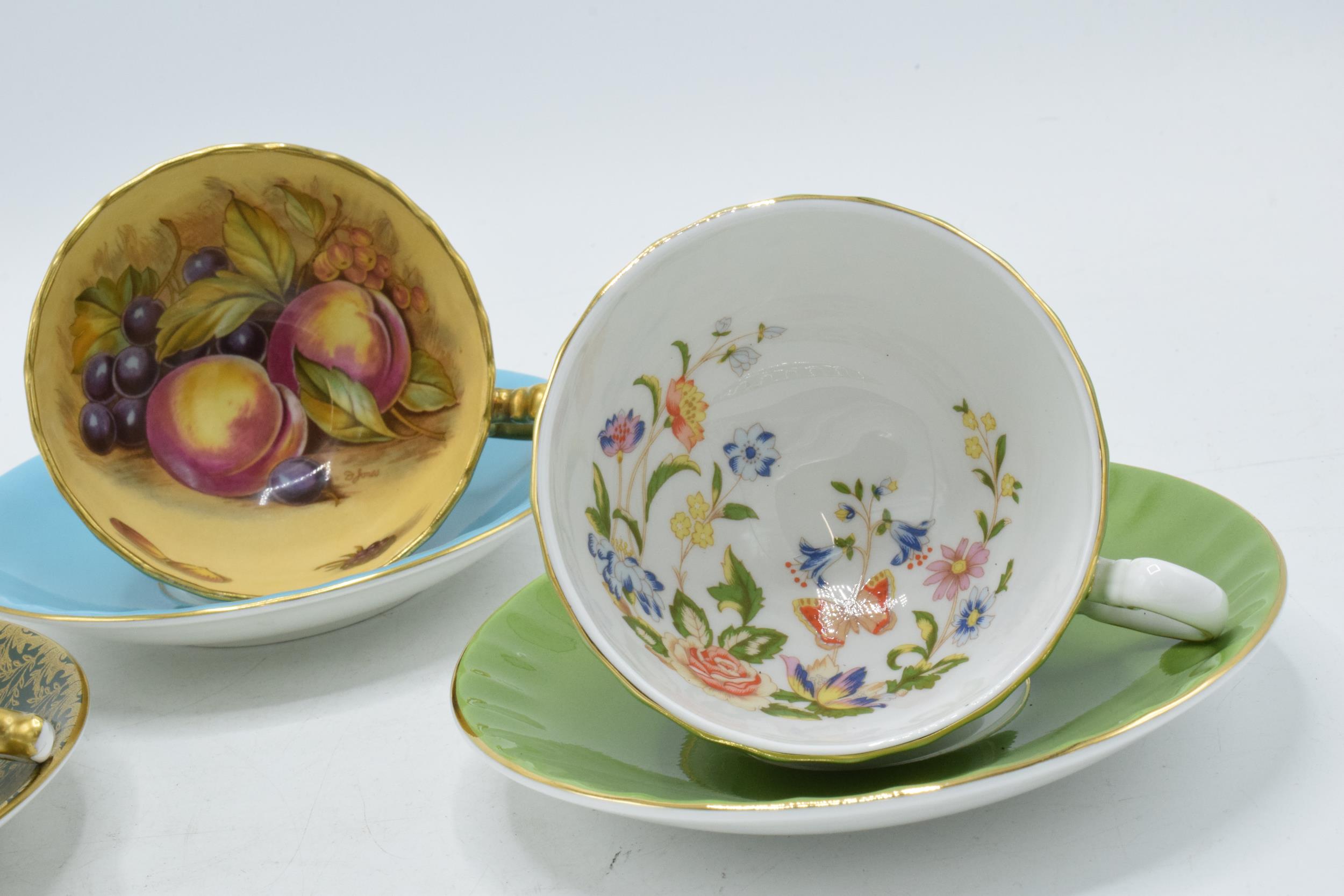 Aynsley cups and saucers to include an Orchard Gold on blue, signed D James, another with a pink - Image 2 of 3