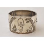 Silver engraved wide bangle with a girl skipping amongst foliage, 47.3 grams. No hallmarks but tests