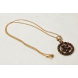9ct gold chain with gilt metal garnet pendant, total weight 4.3 grams.