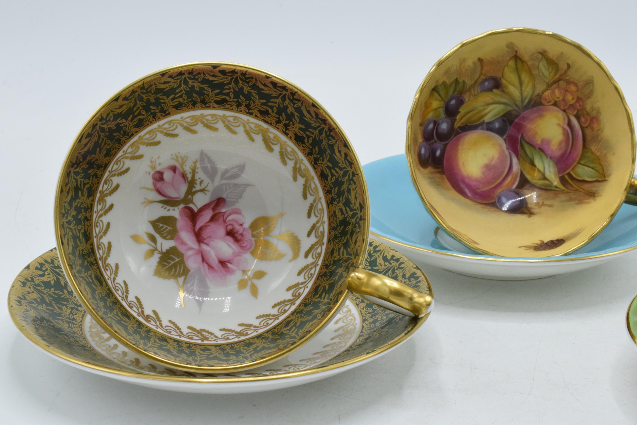 Aynsley cups and saucers to include an Orchard Gold on blue, signed D James, another with a pink - Image 3 of 3