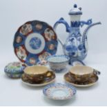A collection of oriental ceramics to include a large ewer with lid, cups and saucers, an Imari