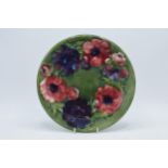 Moorcroft floral charger on green background, 26cm diameter. In good condition with no obvious
