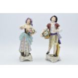 A pair of Rudolf Kammer porcelain figures of flower carriers, height 23cm (2). In good condition