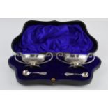 Cased pair of silver salts and spoon, shaped box with velvet lining, gilt interior, Sheffield
