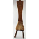 Golden oak spinning stool with carved Stafford Knot to top of the back, in three legs, 99cm tall.