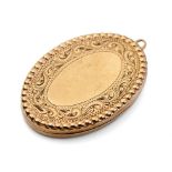 9ct gold oval locket with engraved decoration, 6.2 grams.