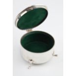 Solid silver circular trinket box raised on 3 feet, with hinged lid and velvet interior, gross