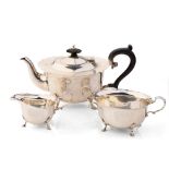 Hallmarked silver tea set to include a teapot, milk and sugar with ebonised wooden handle and