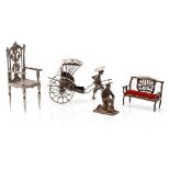 A collection of novelty silver items to include a scene of a gentleman pulling a cart, a