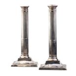 A pair of 26cm tall silver Corinthian column candlesticks, Birmingham 1908, with loaded bases, gross