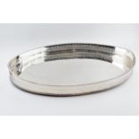 Large Edwardian silver plated oval gallery tray with handles, 61cm wide.