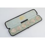 A cased set of 6 silver Art Nouveau buttons with cherubs amongst foliage, RD number, Birmingham