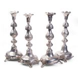 A quartet of Russian silver ornate tall candlesticks, 34cm tall, with leaf and berry pattern