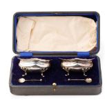 A cased pair of hallmarked silver salts with spoons, Chester 1920, 79.4 grams.