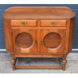 1930s Art Deco oak sideboard with shaped front, 122x45x99cm tall. In good functional condition