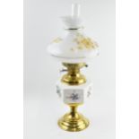 Vintage brass oil lamp with ceramic decoration, 55cm tall.