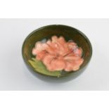 Moorcroft small shallow bowl with hibiscus on green, 8.3cm diameter. In good condition with no
