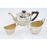 Hallmarked silver 3 piece tea set to include teapot with ebonised handle, milk and sugar bowl, total