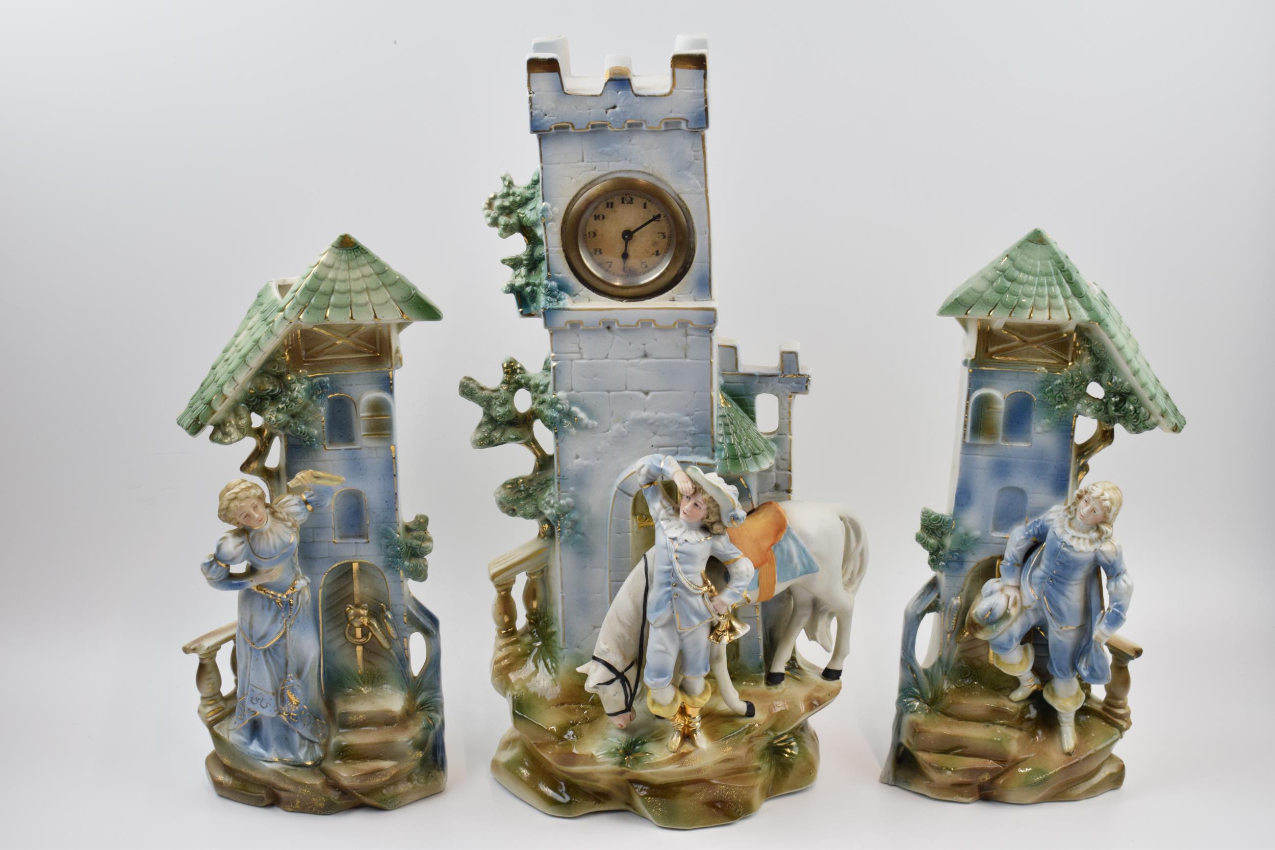 Edwardian continental pottery mantle clock with matching garniture vases (3), 41cm tall. Generally