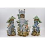 Edwardian continental pottery mantle clock with matching garniture vases (3), 41cm tall. Generally