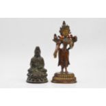 A pair of bronzed Buddha figures to include a seated Buddha on a lotus throne with a standing Buddha