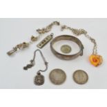 A collection of silver jewellery to include a bangle, a charm bracelet, 2 pre-1920 silver coins,