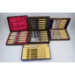 A set of 4 cased cutlery sets / canteens (4).
