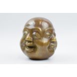 Comical bronzed buddha with 4 faces of differing facial expressions, with character marks to base,