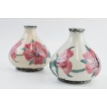 A pair of Cobridge Stoneware pottery vases with pink floral design, 10cm tall (2). In good condition