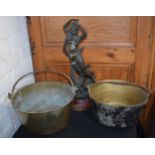 A pair of antique brass jam pans with heavy duty handles, together with a spelter figure of wood