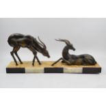 French Art Deco figures of a pair of gazelles mounted onto onyx / marble base, 55cm long. Odd