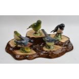 A collection of Beswick birds on a Beswick base, to include, Yellow Wagtail, Bullfinch, Stonechat,