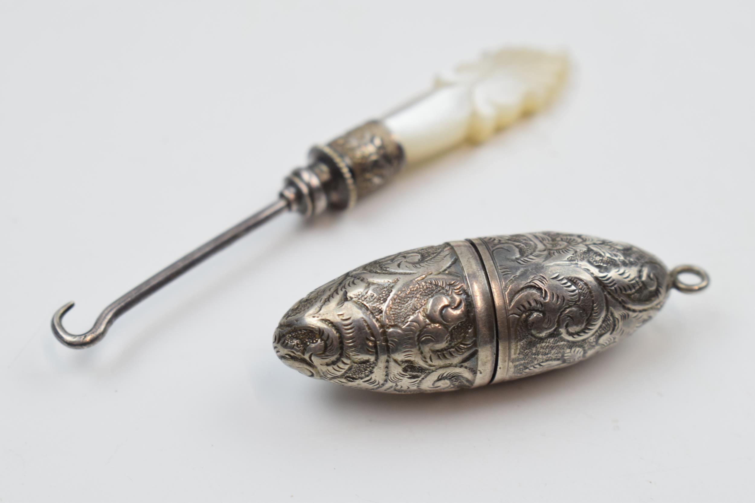 Miniature silver and Mother of Pearl button hook with white metal shaped needlecase with engraved