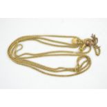 Vintage pinchbeck / yellow metal longuard chain with tassels, circa 150cm long.