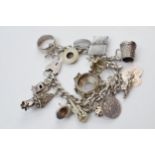 Silver charm bracelet with charms to include a passport, wedding ring, padlock and others, 93.4