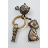 Silver child's rattle with a puppy, a ball and others, in used condition.