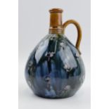 Royal Doulton stoneware bulbous jug with curved handle and floral tubelined decoration, 18cm tall.