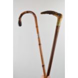 Pair of early walking canes. One with antler horn handle and original feral, one bent bamboo with