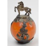A large amber style bead in a novel white metal mount with horse finial, amber style bead 32mm wide,