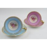 A pair of Aynsley cups and saucers with powder effect design and pink / cabbage rose style