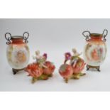 A pair of painted glass vases mounted with gilt metal fittings with a pair of continental putti