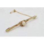 15ct gold opal and pearl bar brooch with central raised opal flanked by 3 seed pearls, 3.6 grams,