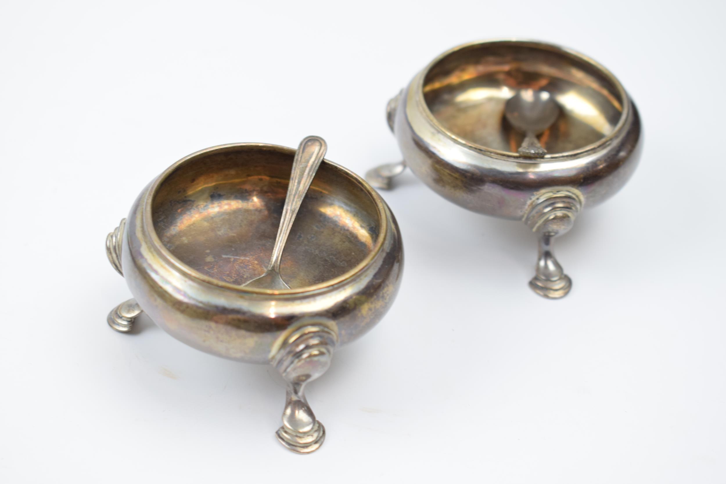 A pair of hallmarked silver George III raised salt cellars on 3 feet, London 1764, Walter Bring,