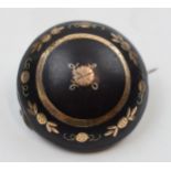Tortoiseshell pique brooch with gold plated inlaid decoration, 27mm diameter.